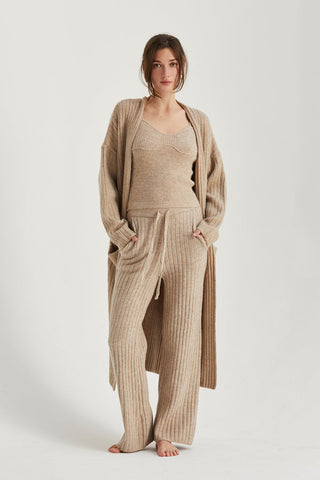 a model in a beige knit loungewear set with a robe