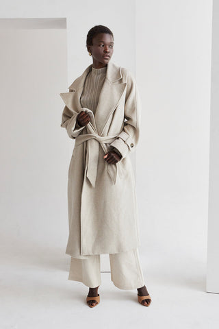 a model in a beige wool coat