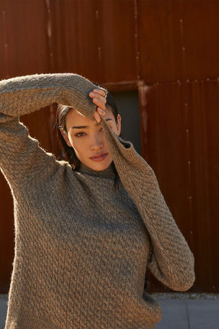 a model in a brown knit sweater