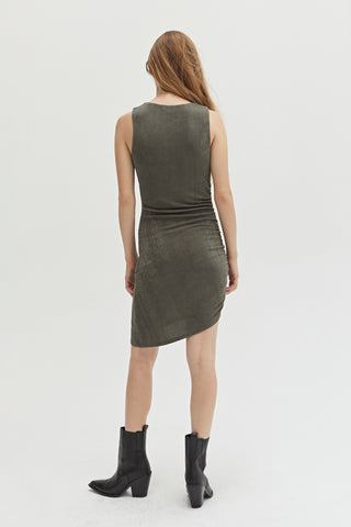 A woman wearing an asymmetrical knit mini dress with side ruching detail.