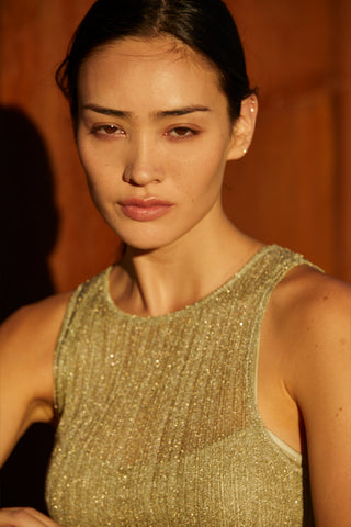 Close up of a  green semi sheer ribbed knit midi dress with inner slip dress.