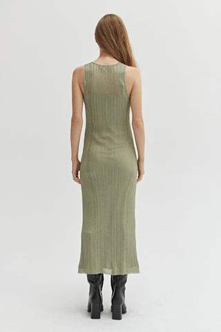 A woman wearing a green semi sheer ribbed knit midi dress with inner slip dress.