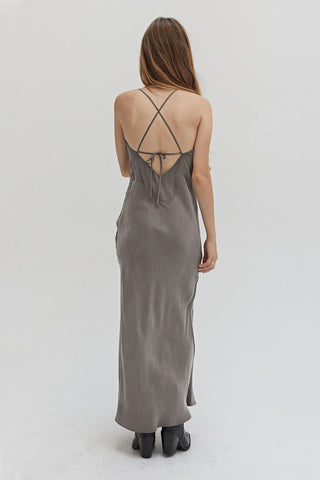 A woman wearing a cupro maxi slip dess in charcoal.