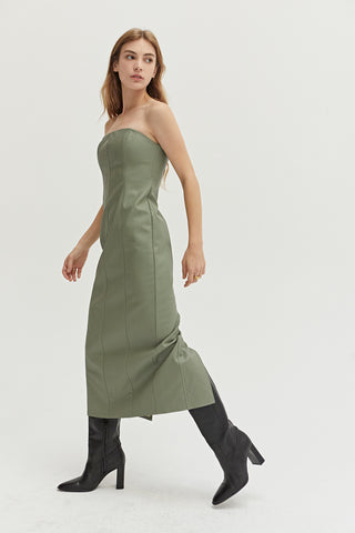 A woman wearing a green vegan leather midi tube dress.