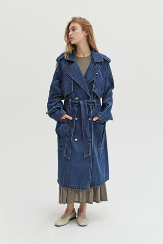 A woman wearing a denim trench coat. 