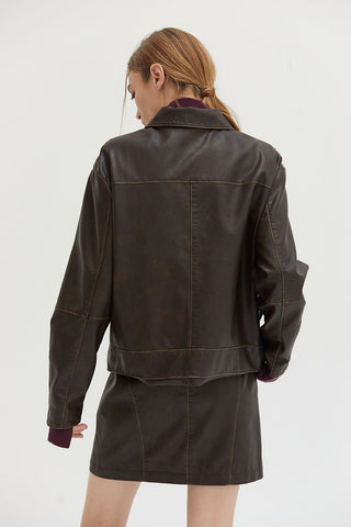 A woman wearing a vintage vegan leather jacket. 