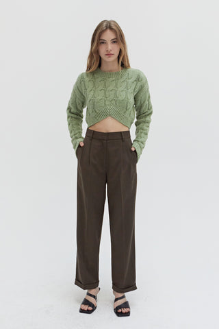 A woman wearing a straight leg cuffed hem trousers.