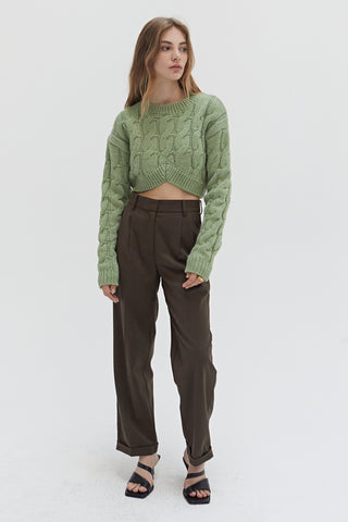 A woman wearing a straight leg cuffed hem trousers.