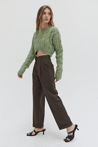 A woman wearing a straight leg cuffed hem trousers.