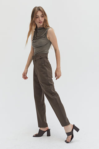 A woman wearing a high waisted seam detailed pants. 