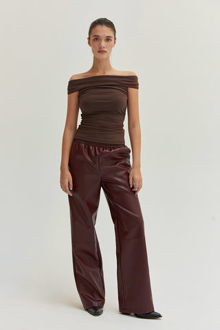 A woman wearing vegan leather pants. 