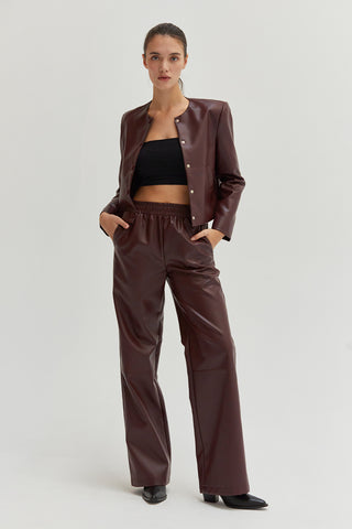 A woman wearing vegan leather pants. 