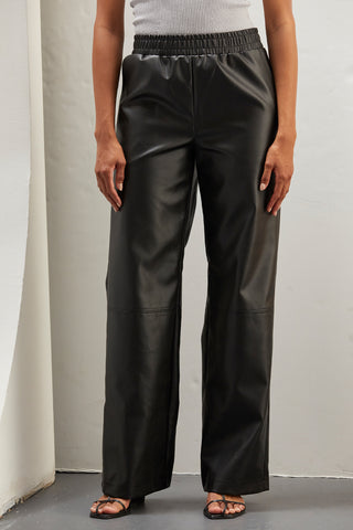 A woman wearing vegan leather pants. 