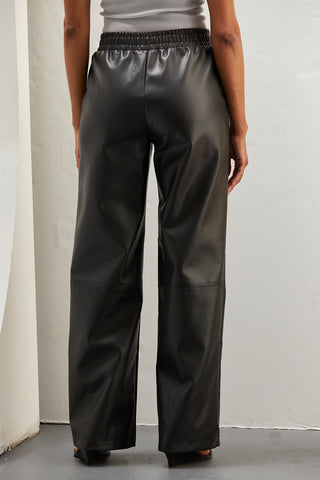 A woman wearing vegan leather pants. 