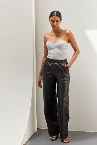 A woman wearing vegan leather pants. 