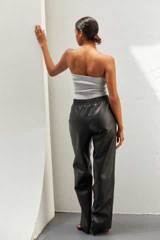 A woman wearing vegan leather pants. 