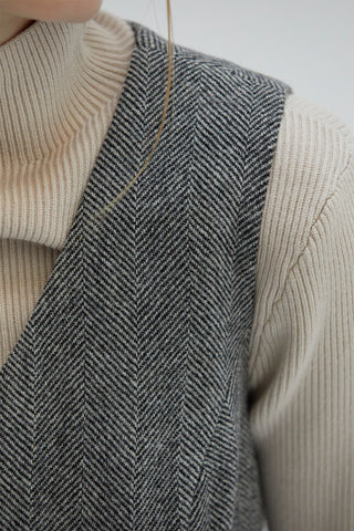 A close up of the wool material of the vest with herringbone pattern. 