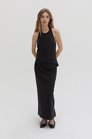 A woman wearing a tencel wool blend halter top with front seam detail. 