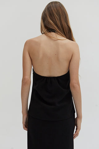 A woman wearing a tencel wool blend halter top with front seam detail. 