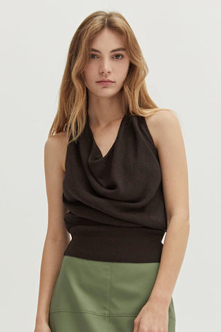 A woman wearing a cowl neck halter sweater knit top.