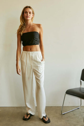 model wearing loose white tencel pants