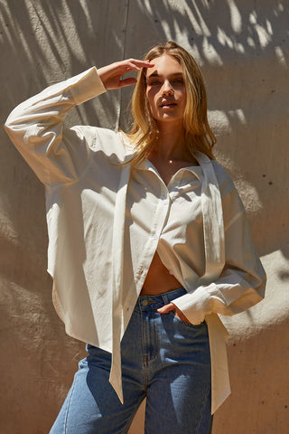 a model in a white shirt and denim jeans