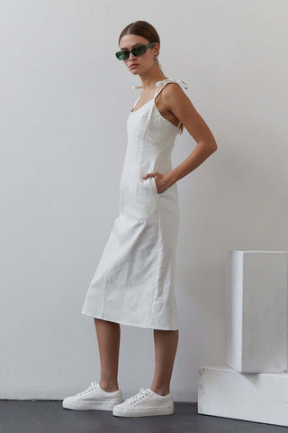 model posing wearing a white denim dress